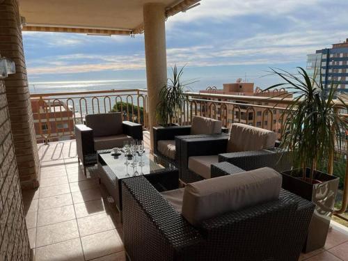 a patio with couches and a table on a balcony at Apartamento en Benicassim. in Benicàssim