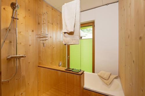 a bathroom with a shower and a bath tub at Kronenwiese in Mosnang
