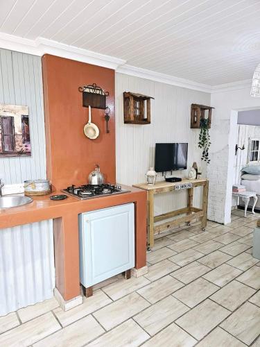 a kitchen with a stove and a counter top at Le'Cottage Scottburgh in Scottburgh