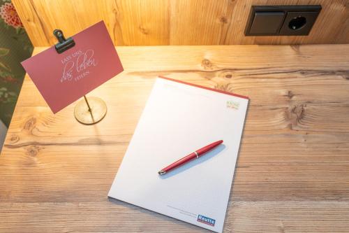 a pen sitting on top of a paper on a table at Hotel Krone Tirol in Reutte