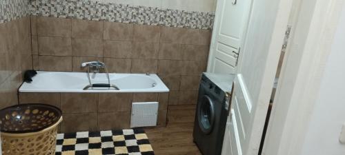 a bathroom with a sink and a washing machine at La Brise Marine in Sousse