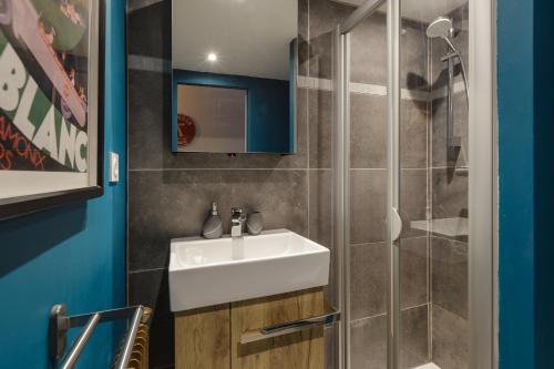 a bathroom with a sink and a shower at Beautiful mountain view studio by the lake in Chamonix