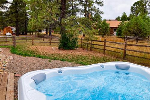a hot tub in a yard next to a fence at Quartz Court in Pagosa Springs