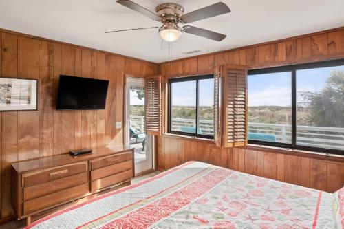 a bedroom with a bed and a flat screen tv at Fripp Island 702 Tautog in Fripp Island