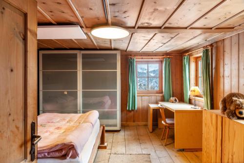 a bedroom with a bed and a desk at Liberty Ranch Marlstein in Oetz