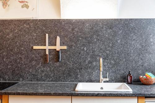 a counter with a sink and two crosses on the wall at Liberty Ranch Marlstein in Oetz