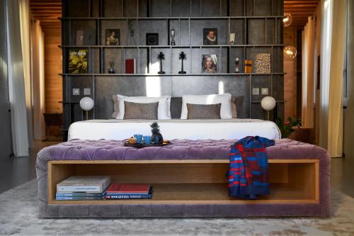 a bedroom with a large bed with a purple blanket at Fornace Suite in Florence