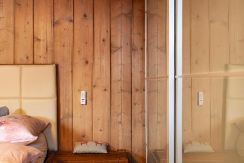 a bedroom with wood paneled walls and a bed at Liberty Ranch Marlstein in Oetz