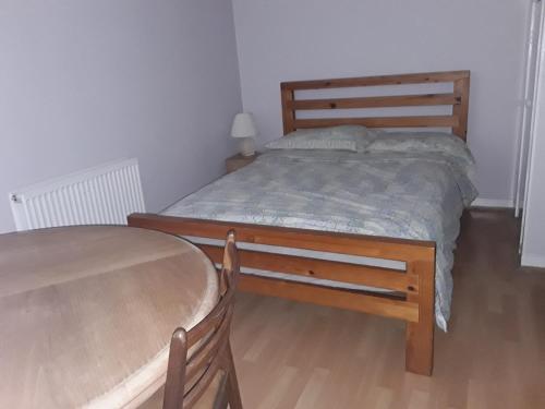 a small bedroom with a bed and a table at Robs Place, Liverpool in Liverpool