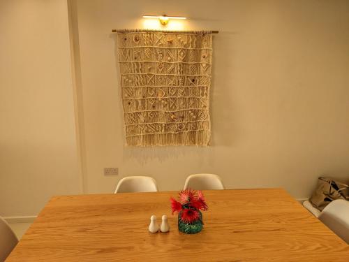 a wooden table with a vase on top of it at Seaview serenity apartment in Flic-en-Flac