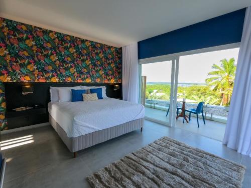 a bedroom with a bed and a large window at The View - Adults Only Resort in Pipa