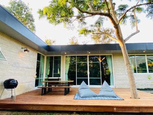 a wooden deck with a bench and a table at New Chapter House, 3 big bedroom, 1.5 km to centre in Pai