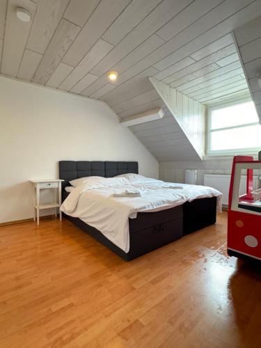 a bedroom with a large bed in an attic at Der Schwan 7 - 2 Balkone - zentral - 100 qm in Düren - Eifel