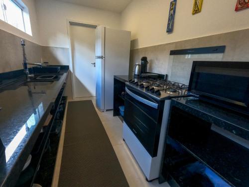 a kitchen with a stove and a counter top at The View - Adults Only Resort in Pipa