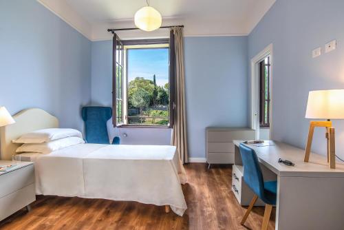 Schlafzimmer mit einem Bett, einem Schreibtisch und einem Fenster in der Unterkunft HOTEL DELLE CIVETTE in Rom
