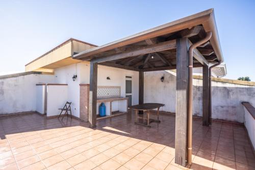 an outdoor patio with a table on a roof at Il Sole di Scalea in Scalea