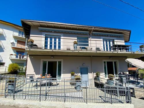 a house with tables and chairs on a balcony at Appartamenti Golfo Borromeo 3 e 4 Baveno in Baveno