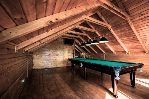 a pool table in a room with a wooden ceiling at Садиба на Кодимі in Archipitovka