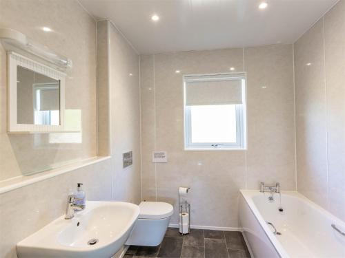 a bathroom with a sink and a tub and a toilet at 3 bed in Moffat CA402 in Moffat