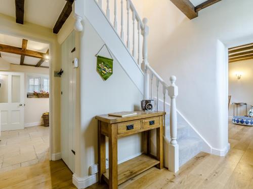 a staircase in a home with a wooden table at 3 Bed in Wetton 79554 in Wetton