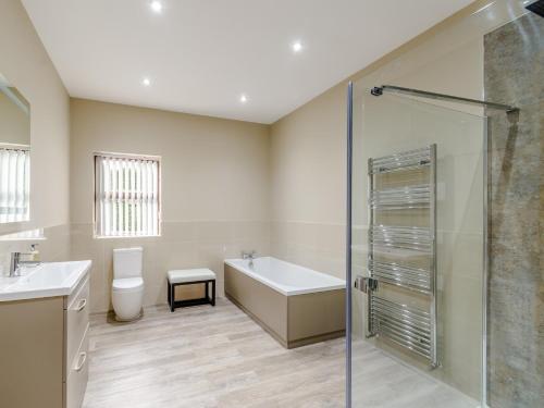 a bathroom with a tub and a toilet and a shower at 2 bed in Hamsterley 80004 in High Etherley
