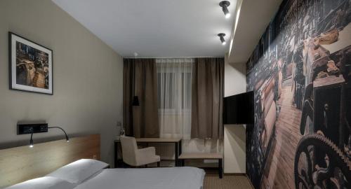 a hotel room with a bed and a desk at Iness Hotel in Łódź