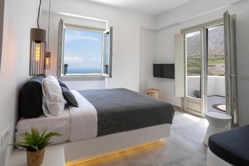 Un ou plusieurs lits dans un hébergement de l'établissement Maeva Suites Santorini