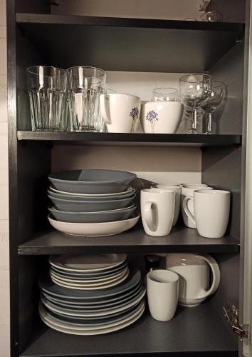 a shelf filled with plates and cups and dishes at Apartaments Gory in Niedzica Zamek