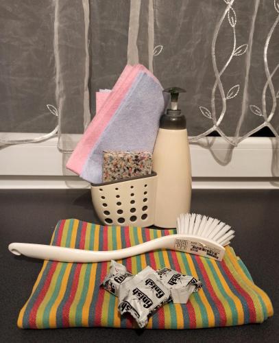 a toothbrush and a bottle on a towel at Apartaments Gory in Niedzica Zamek