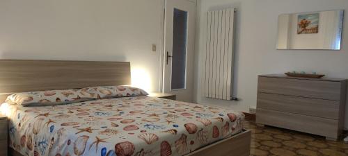 a bedroom with a bed and a dresser in it at DREAM HOUSE Casa Vacanze in Arma di Taggia
