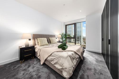 a bedroom with a bed and a large window at Central London New 2 bedroom flat Riverview Balcony in London