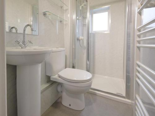 a bathroom with a toilet and a sink and a shower at 2 Bed in Keswick SZ009 in Keswick