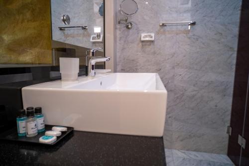 a bathroom with a white sink and a mirror at Hotel Atina in Budva