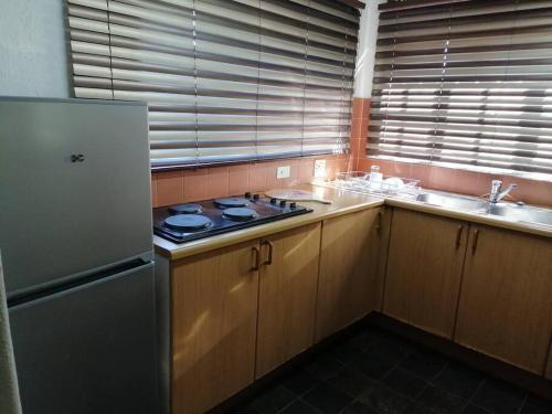 a kitchen with a stove and a sink at Traveller's dream in Graskop