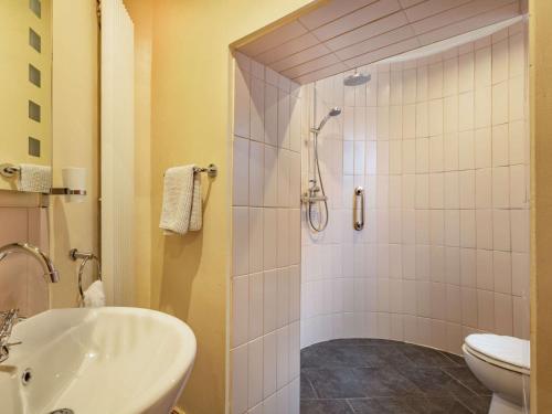 a bathroom with a shower and a sink and a toilet at 1 Bed in Crieff 87497 in Crieff