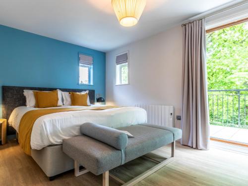a bedroom with a large bed and a window at 2 Bed in St. Mellion 87707 in St Mellion