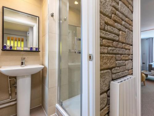 a bathroom with a sink and a shower at 2 Bed in St. Mellion 87707 in St Mellion