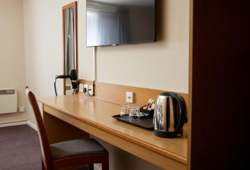 a hotel room desk with a toaster on top of it at The Quays by Greene King Inns in Northampton