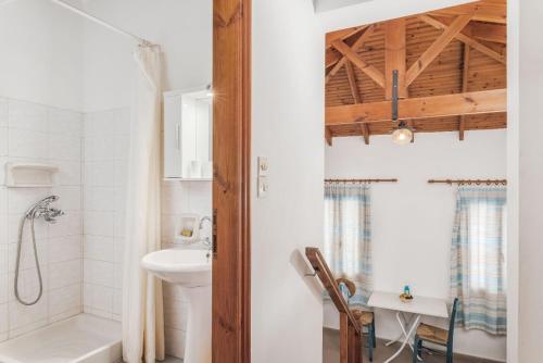 a white bathroom with a sink and a toilet at Vigla-Βίγλα 1 2 in Órmos Marathokámpou