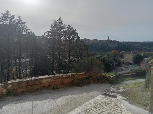 a stone wall with a view of a city at IL NIDO DEL FALCO in Pitigliano