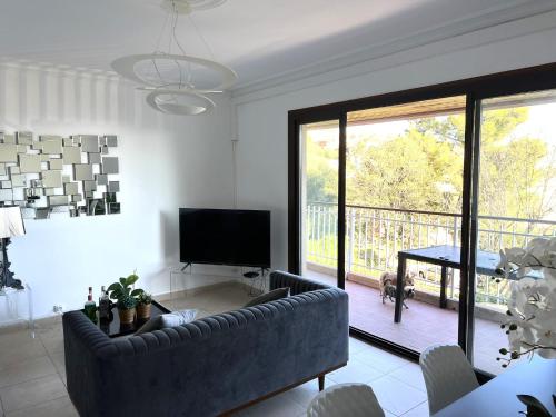 un salon avec un canapé et une télévision et un balcon dans l'établissement VACANCES RAFFINEES A PIETRANERA, à San-Martino-di-Lota