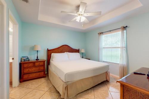 a bedroom with a bed and a ceiling fan at Augusta Casita at SPI Golf Course in Laguna Vista