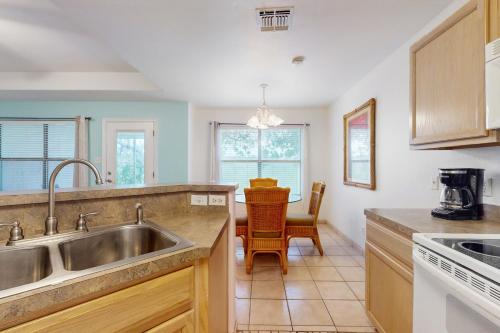 a kitchen with a sink and a table at Augusta Casita at SPI Golf Course in Laguna Vista