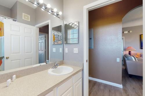 a bathroom with a sink and a mirror at Family Fiesta in Orlando