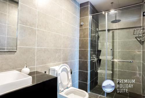 a bathroom with a toilet and a sink and a shower at Premium Holiday Suite beside Lost World Tambun in Tambun