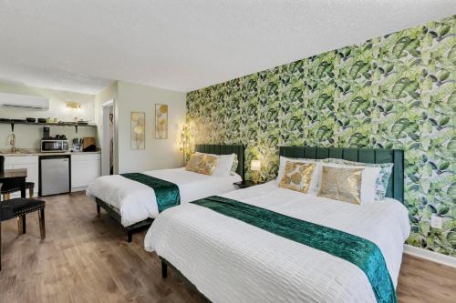 a hotel room with two beds and a kitchen at Beachside Boutique Suite 4 in Sneads Ferry