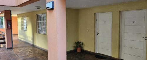 a hallway with two white doors in a house at Nuestra Recova en Pilar BsAs in Pilar