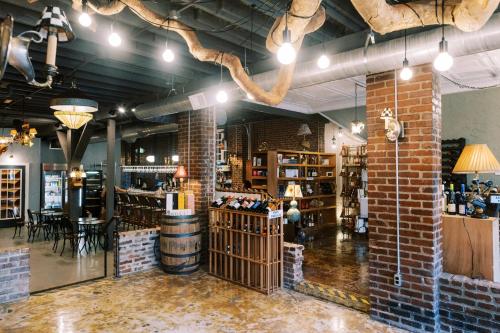 a room with a brick wall and a wine cellar at The NuWray Hotel & Carriage House in Burnsville