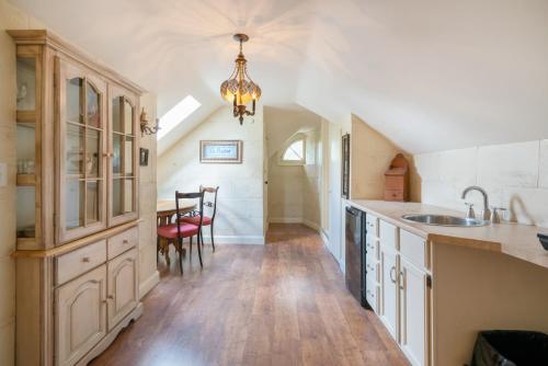 a kitchen with a sink and a dining room at Lion's Head B&B in Niagara Falls