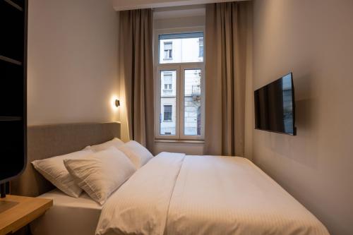 Hop Inn Rooms & Suitesにあるベッド